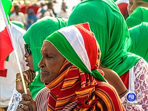 a picture of an eldery women holding the flag of republic of Somaliland on the 18th may 2021