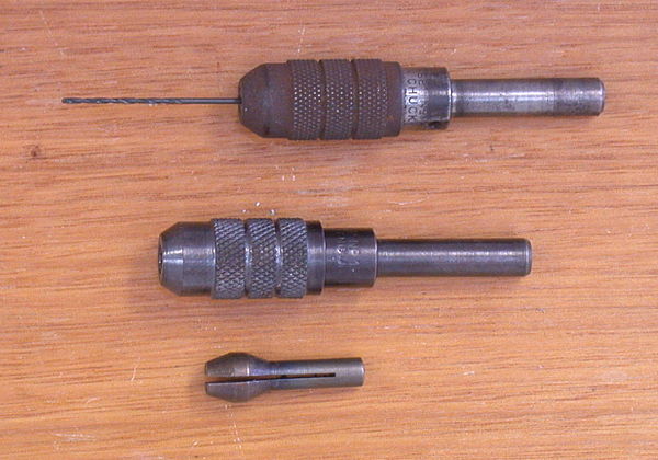 Two pin chucks. The top one is assembled, the lower one shows the body and nose cap assembled with the collet piece below it.