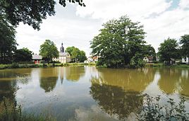 View over the village pond to the church