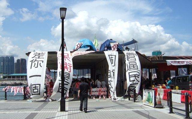 Banners erected by protesters, tents on the rooftop