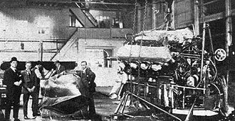 The Supermarine Sea Lion II hull and Napier Lion engine prior to be installed. Mitchell is standing second-to-left. Sea Lion II hull and Napier Lion engine on display.jpg