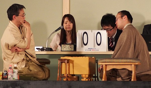 Professional shogi players, Yoshiharu Habu and Akira Watanabe, in 2014 with women's professional player Aya Fujita as timekeeper and (former) apprenti