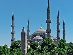 Sultan Ahmed Mosque is known as the Blue Mosque due to the blue Iznik tiles which adorn its interior. The Obelisk of Thutmose III (Obelisk of Theodosius) is seen in the foreground. Sultanahmet Camii, Istanbul.jpg