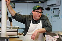 Mylan leaning on the counter at his butcher shop, The Meat Hook, in Williamsburg, Brooklyn