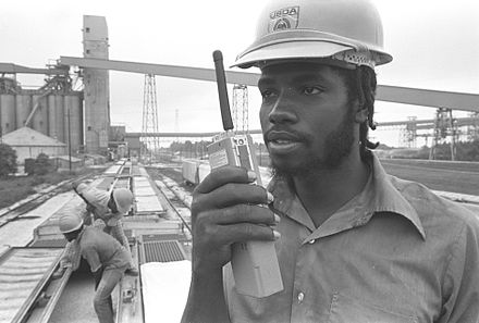 A USDA grain inspector with RCA TacTec walkie-talkie, New Orleans, 1976