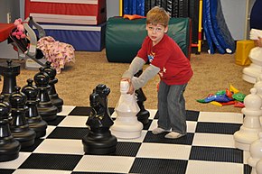 Touching a piece can incur consequences in competitive chess, but typically not in informal play. USMC-120210-M-TR039-003.jpg