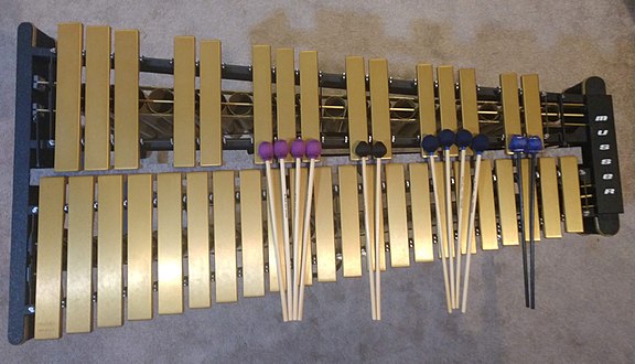 An overhead view of a 3 octave vibraphone with different mallets of varying hardness.