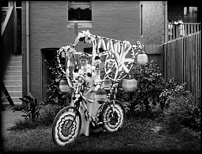 View of woman holding a fancily decorated bicycle, Australia c.1900