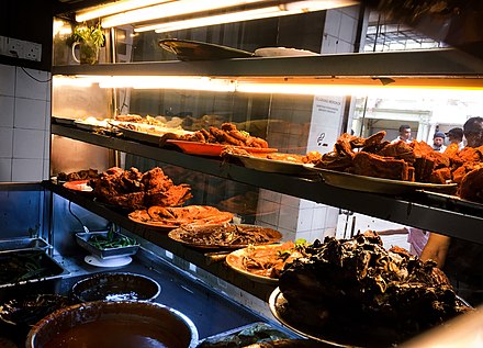 An assortment of different curries, sides dishes and gravies commonly paired on a plate of Nasi Kandar
