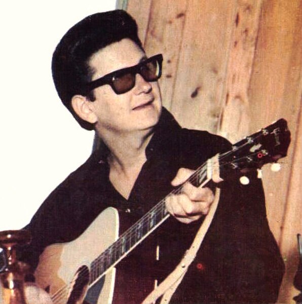 Orbison performing in his trademark dark glasses