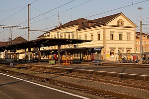 Wide three-story building with gabled roof