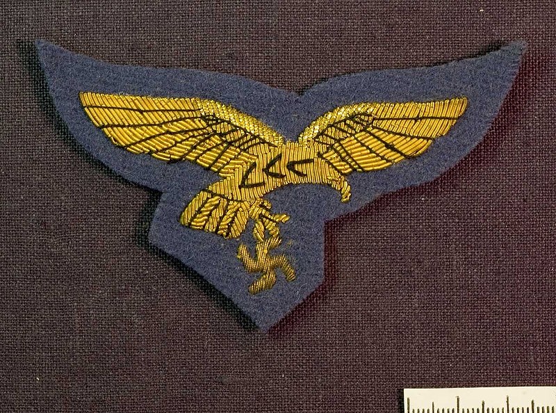 File:AM.088278 Reichsadler der Luftwaffe LW Hoheitsadler Brustadler. German Third Reich Air Force eagle-and-swastika national insignia embroidered uniform cloth patch badge. Yellow on bluegray backing. Photo Armémuseum Sweden CC BY 4.0 Cro.jpg
