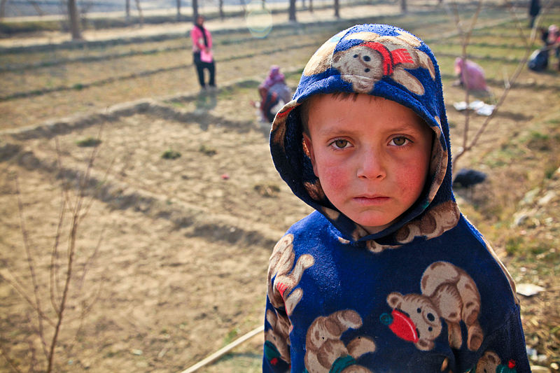 File:An Afghan child poses for a photo as women work in a field in the Charikar district, Parwan province, Afghanistan, Jan. 3, 2012 120103-A-LP603-081.jpg