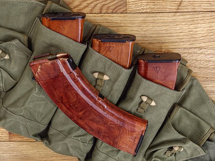 "Bakelite" rust-colored steel-reinforced 30-round plastic box 7.62×39mm AK magazines. Three magazines have an "arrow in triangle" Izhmash arsenal mark on the bottom right. The other magazine has a "star" Tula arsenal mark on the bottom right