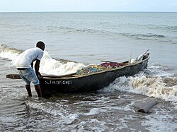 A fisherman on the beach at Praia Melão