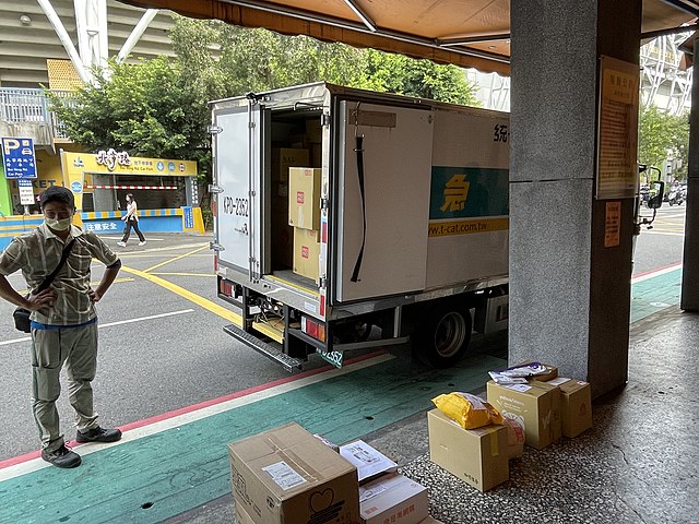 Courier in Taipei, Taiwan, organizing parcels for delivery