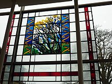 Commemorative stain window located in the Sulston building of the Wellcome Sanger Institute, to mark the opening of the Genome Campus. DNA Helix and Tree of Life stain glass window.JPG