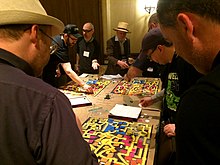 Dave Megarry leading a session of Dungeon! at Gary Con, using the original published edition. Dave Megarry Dungeon Gary Con 2018 1.jpg