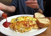 A Denver omelette (top) with toast, hash browns and tomato ketchup