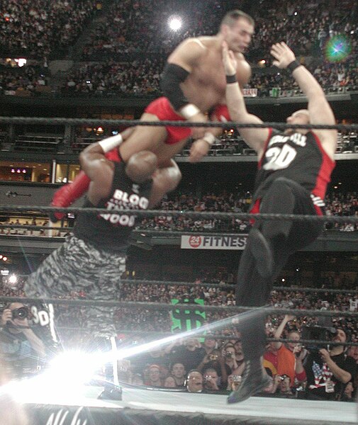 D-Von (left) and Bubba Ray (right) performing the Dudley Death Drop on Lance Storm.
