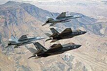 A pair of F-35Cs and F/A-18E/Fs fly over NAS Fallon, home of TOPGUN, in September 2015.