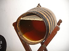 Sherry barrel made with glass barrel head to show the layer of flor floating on top of the aging wine. FLOR-ValdiviaJerez59.jpg