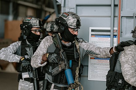 MARCOS prepare to enter a hatch during VBSS training during RIMPAC 2022