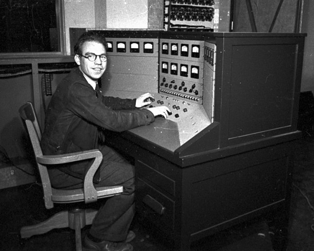 Photo of Backus at the control panel for the Berkeley Lab 60-inch cyclotron