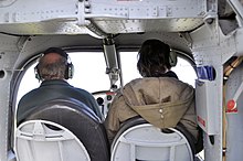 Forward-facing view from inside the cabin, note the pilot at the controls Luftaufnahmen Nordseekueste 2012-05-by-RaBoe-004.jpg