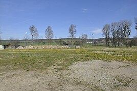 The area of ​​the former manor with a pile of stones, the remains of the demolished ruin.