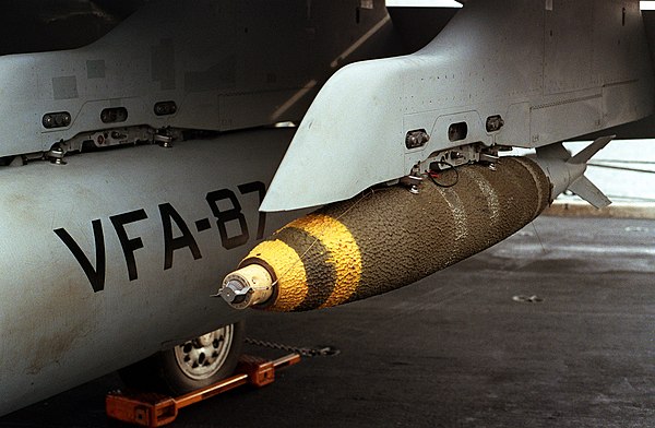 A Mk 82 GP bomb loaded on an F/A-18 Hornet, showing nose fuze and textured thermal insulation