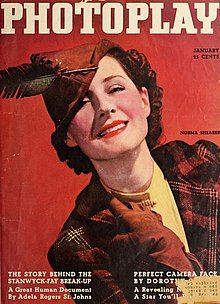 Woman in a poster, smiling and wearing a hat