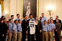 President Barack Obama poses for a picture while holding up a jersey given to him by members of the Little League World Championship team from Chula Vista, Calif., in the East Room of the White House, Feb. 5, 2010. (Official White House Photo by Pete Souza) Obama Little League.jpg