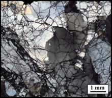 Cross polarized image of a high concentration of variably oriented joints within a granitic rock from the San Andreas Fault, California. No obvious displacement along fractures. Opening Mode Fractures.png