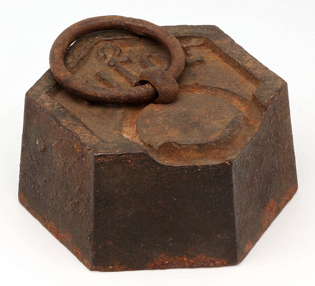 A 2 kg (4.4 lb) cast iron weight used for balances