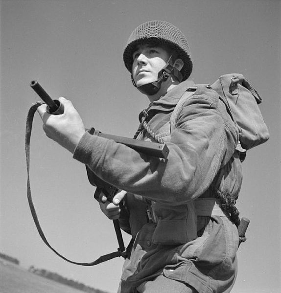 British paratrooper of the 8th Parachute Battalion armed with the Sten gun wearing the airborne forces steel helmet and the Denison Smock (1943).