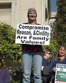 A woman at the Rally to Restore Sanity and/or Fear holding a sign that declares her ideas of family values Reason Civility Family Values Rally for Sanity crop.jpg