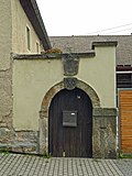 Gate and keystone walled in over it in the courtyard wall of a farm