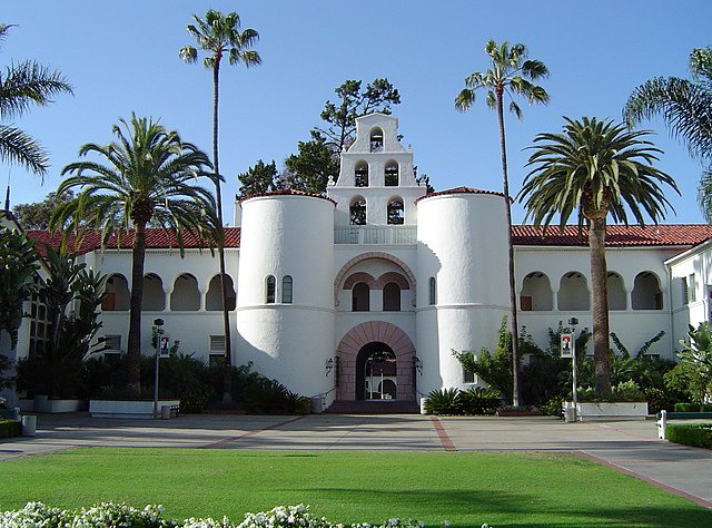 A landmark building (Hepner Hall) featured in the school's logo