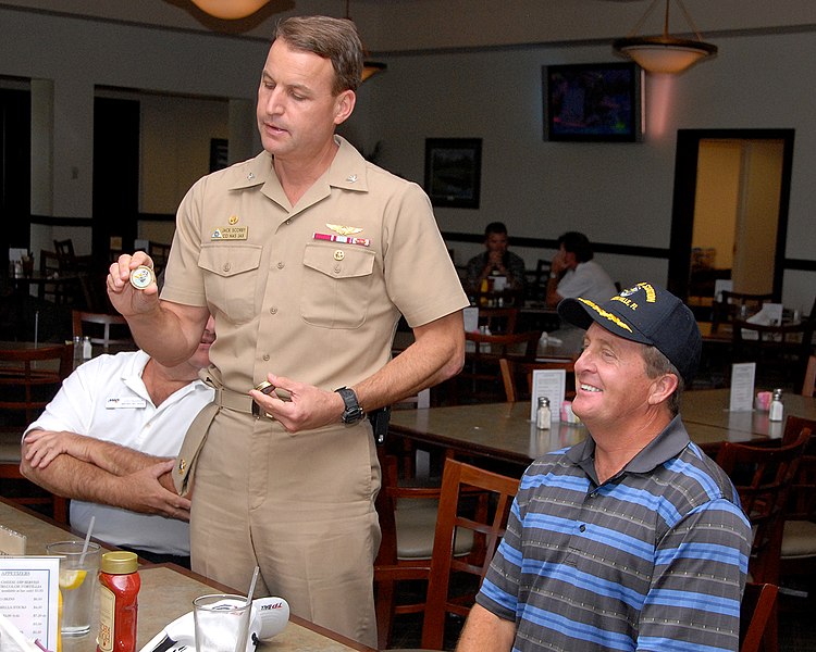 File:US Navy 090421-N-3013W-035 Capt. Jack Scorby, Commanding Officer of Naval Air Station, Jacksonville, presents professional golfer Fred Funk with a command ball cap and coin.jpg