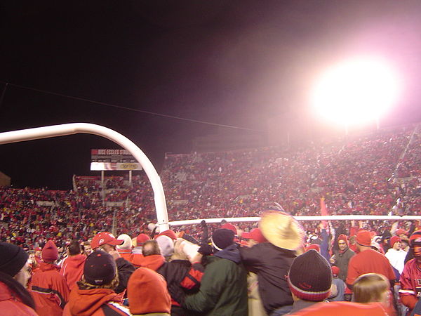 Utah Utes fans rush the field and carry the goalpost after defeating rival BYU in November 2004, completing a perfect regular season, and becoming the