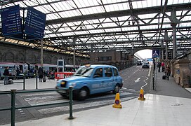 Taxi entering the station. On 2 June 2014 taxis were banned from entering the station concourse and now have to use taxi ranks outside the station.