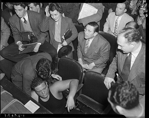 Jules Strongbow is knocked out of the ring during a wrestling match at the Grand Olympic Auditorium on May 16, 1937.