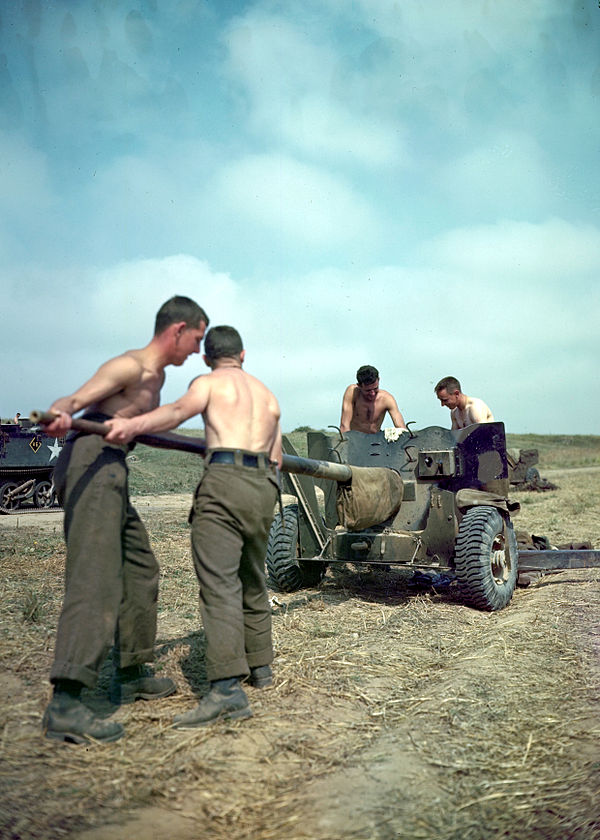 A Canadian gun crew performing maintenance on the bore of their 6-pounder.