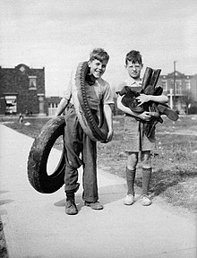 Two boys in Montreal in April 1942 collect rubber tires and boots to be recycled as part of Canada's war effort. Children collecting rubber.jpg