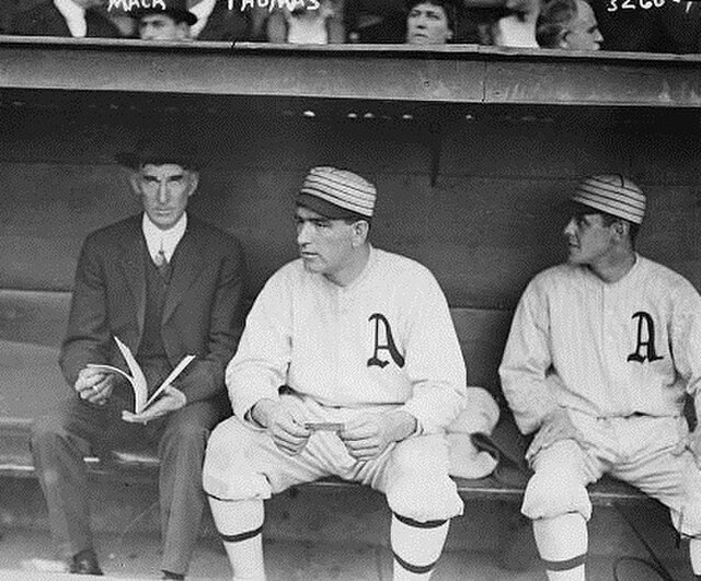 Hall of Fame manager Connie Mack with the Philadelphia Athletics (left) wearing a suit instead of a team uniform