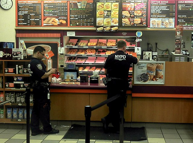 Police officers buying doughnuts and coffee, an example of perceived stereotypical behavior in North America