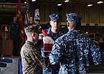 Thumbnail for File:From left, U.S. Marine Corps Gunnery Sgt. Trevor Bates assists Navy Damage Controlman 1st Class Wayne Jones and Navy Air-Traffic Controller 1st Class Fernando Montes, both selected for promotion to chief petty 140911-N-CC789-130.jpg