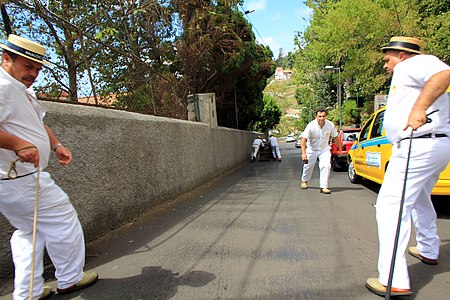 Drive on traditional basketwork sledges operated by "carreiros" for tourists in the city Funchal, Madeira