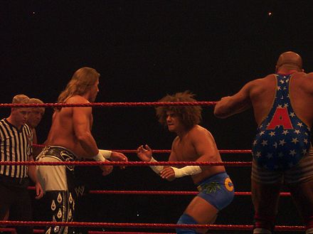 Carlito and Kurt Angle facing off against Shawn Michaels and Ric Flair at a WWE house show